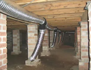 Subfloor ventilation equipment used to extract moisture beneath a home